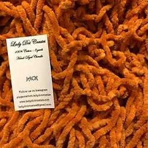 May include: A close-up of a large pile of orange chenille stems. The stems are soft and fluffy, and they are perfect for crafting.