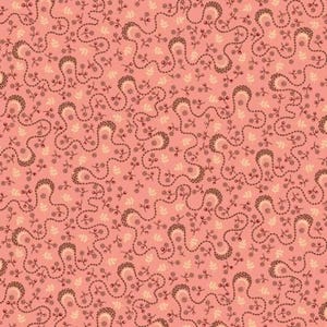 May include: A fabric pattern featuring a salmon pink background with a repeating design of dark brown wavy lines, small dark brown floral sprigs, and light cream-colored leaf motifs scattered throughout the surface in a continuous arrangement.