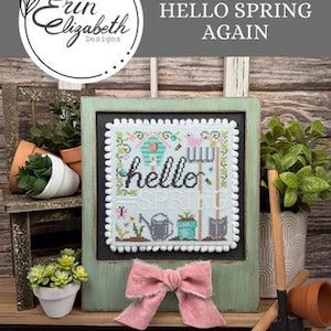 May include: Cross stitch pattern with a green chalkboard frame and a pink bow. The pattern features a birdhouse, flowers, and the words "hello spring again". The stitch count is 70w by 70h and the fabric is 28 count Ice Blue Lugana.