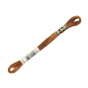 May include: A single skein of brown embroidery floss, labeled with the number 433. The floss is tightly wound and has a loop at one end. The label includes the brand name and other details.