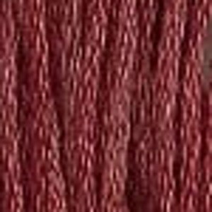 May include: A close-up of a deep red textured fabric with a subtle sheen. The fabric has a woven pattern that creates a raised, almost bumpy surface.