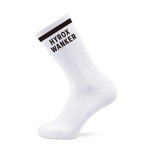 May include: White athletic sock with a black band at the top and the words "HYROX WANKER" printed in black. The sock is made of a ribbed material and is angled slightly to the left against a white background.