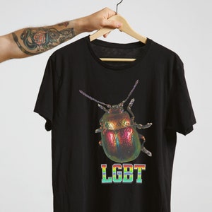 May include: Black t-shirt with a rainbow iridescent beetle graphic and the text "LGBT" printed in rainbow colors.
