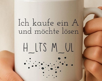 May include: White ceramic mug with black text that reads "Ich kaufe ein A und möchte lösen H_LTS M_UL" and a pattern of black dots. The mug has a handle and is held by a person.