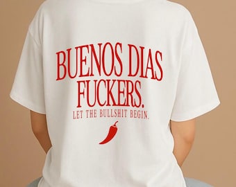 May include: A white short-sleeved t-shirt featuring red text on the back that reads BUENOS DIAS FUCKERS. LET THE BULLSHIT BEGIN. Below the text is a small red chili pepper graphic. The shirt has a crew neckline and a standard fit.
