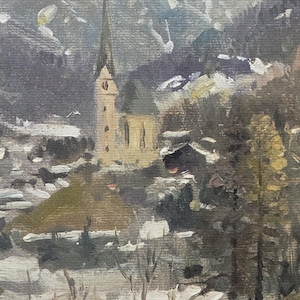 May include: Oil painting of a European village in winter. A tall church steeple rises above the buildings, surrounded by snow-covered hills and trees. The color palette is muted, with shades of gray, brown, and white.