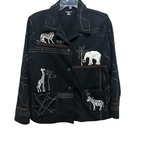 May include: Black jacket with embroidered safari animals, including a leopard, giraffe, elephant, and zebra. The jacket has a button-up front, two pockets, and white stitching details. The brand name "Allison Daley" is visible on the label.