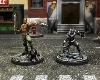 Pantera Negra y Killmonger pintados a mano de la película Crisis Protocol de Marvel.