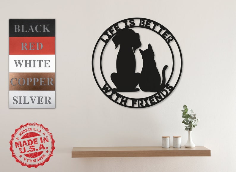 May include: Black metal wall decor with a dog and cat silhouette inside a circle. The text "Life is better with friends" is written around the circle.