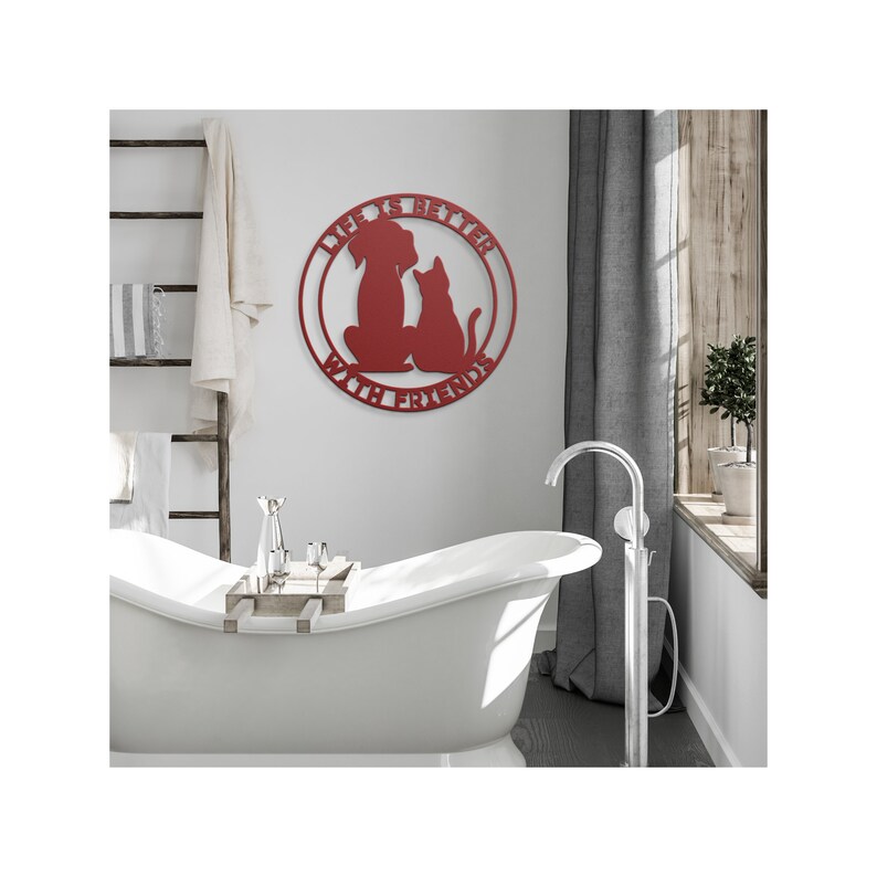 May include: Red metal wall art with a dog and cat silhouette inside a circle. The text reads "Life is better with friends".