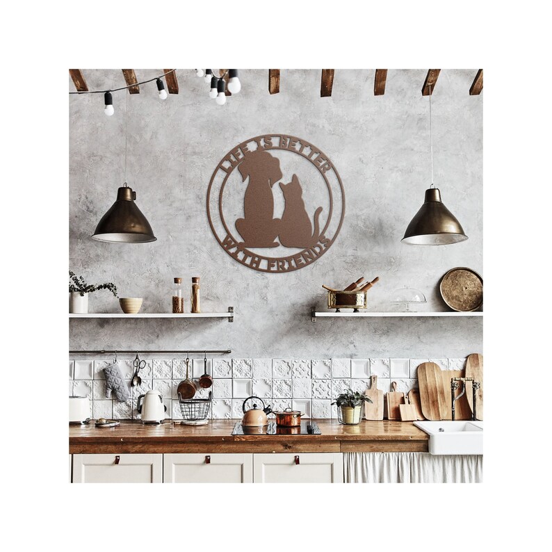 May include: A brown metal wall decor with a dog and cat silhouette inside a circle. The circle has the text "Life is better with friends". The decor is hanging on a gray wall in a kitchen setting.