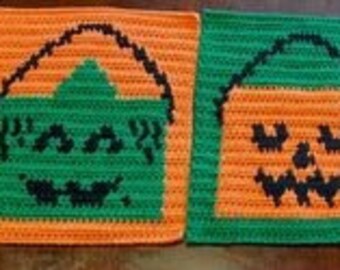 May include: Three crocheted Halloween-themed squares. The first square is orange and green with a pumpkin face. The second square is green and orange with a pumpkin face. The third square is purple and white with a ghost face.