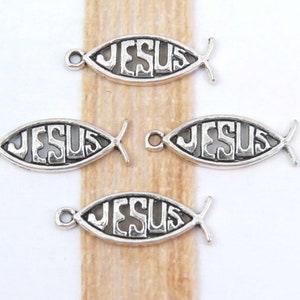 May include: Four silver-toned metal charms shaped like fish with the word "JESUS" inscribed inside. The charms have a loop at the top for attaching to jewelry or other crafts.