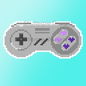 May include: A pixelated illustration of a gray Super Nintendo Entertainment System (SNES) controller with black buttons and purple and black face buttons. The text "Shutterpie Designs" is visible at the top of the image.