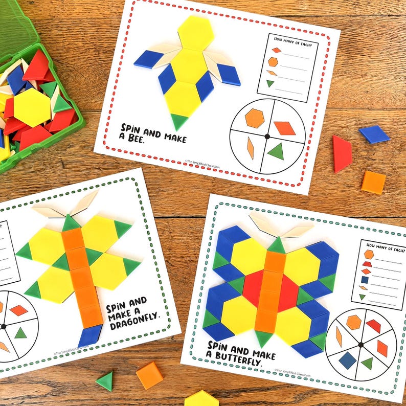 May include: Educational activity set with colourful geometric shapes and three instruction cards. The cards show images of a bee, dragonfly, and butterfly, with the text "Spin and Make" and shape guides. A green container holds extra shapes.