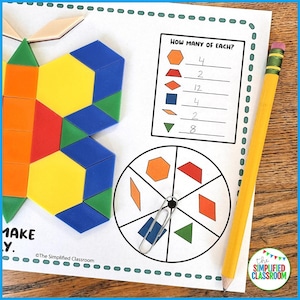 May include: An educational worksheet with geometric shapes and a pencil. The worksheet shows a butterfly made of shapes, a chart asking "How Many of Each?", and a shape spinner. A yellow pencil with a pink eraser rests on the page.