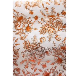 May include: White background with a repeating pattern of copper-colored floral designs. The flowers are stylized and have a vintage look.