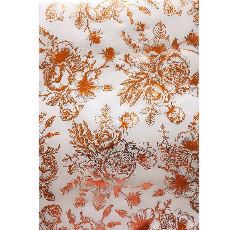 May include: White background with a repeating pattern of copper-colored floral designs. The flowers are stylized and have a vintage look.