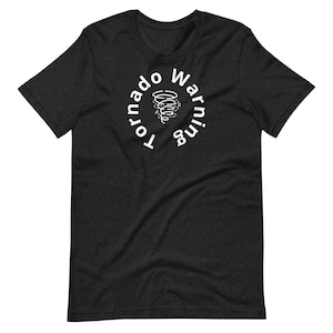 May include: Dark gray t-shirt with the words "Tornado Warning" in a white circular design. The design includes a white illustration of a tornado. The shirt is made of a soft material.