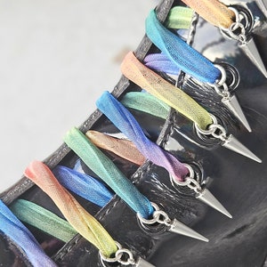 Pointy pokey spikey things to adorn the laces of your Dr Martens Boots! Stainless steel spike charms to THREAD your laces through.