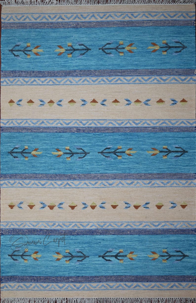 Handwoven kilim rug in blue and beige, flatweave wool with geometric tribal motifs and borders