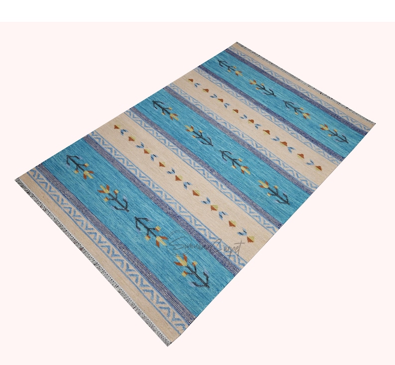 Handwoven kilim wool rug in blue and beige with tribal geometric motifs and border—flatweave carpet, boho decor.