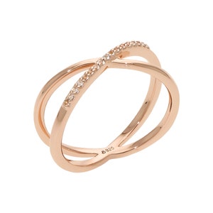 May include: Rose gold-colored ring with a crisscross design. One band is adorned with small, clear gemstones. The ring is marked with "925" on the inside. The ring is a piece of jewelry.