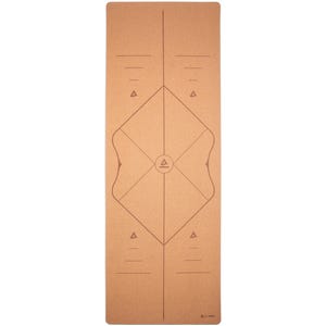 May include: A rectangular yoga mat in a natural cork colour. The mat features a geometric design with lines, triangles, and a central emblem. The design is in a darker shade of brown. The mat is designed for yoga and fitness activities.