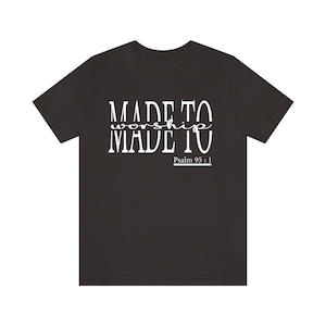 May include: Black t-shirt with white text that reads "MADE TO worship MADE TO" and "Psalm 95:1".