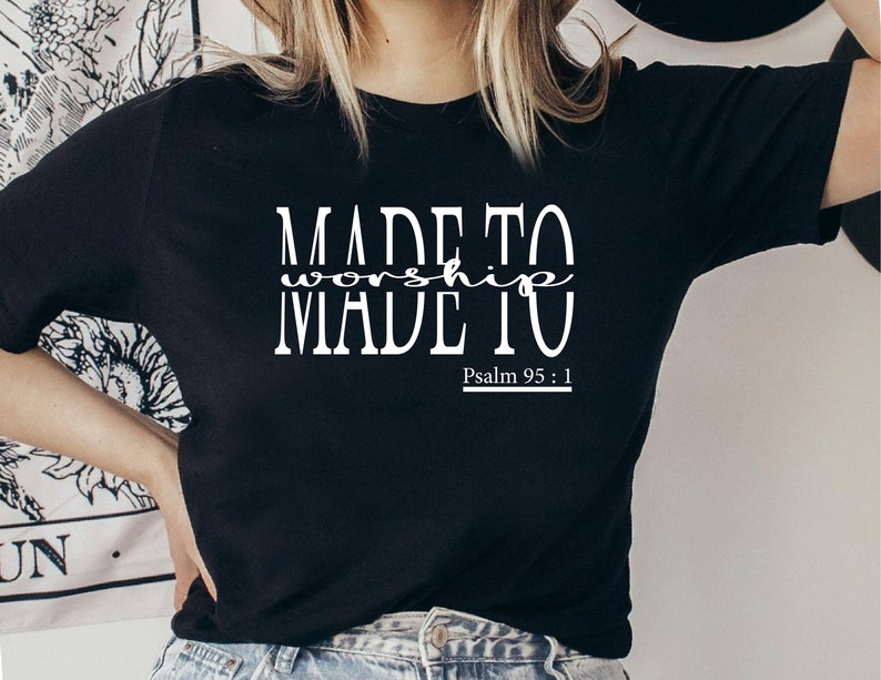 May include: Black t-shirt with white text that reads "MADE TO worship MADE TO" and "Psalm 95:1".