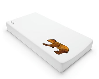 May include: White rectangular object featuring a brown bear illustration. The bear is composed of geometric shapes in shades of brown and gold. The letters "KCPA" are printed in the upper left corner.