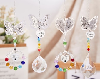 May include: Four silver hanging ornaments with rainbow crystal beads and a crystal prism. Each ornament features a different design: a butterfly, a heart, a butterfly, and a heart. The hearts have the names "Harley", "Buddy", "Gracie", and "Bailey" on them.