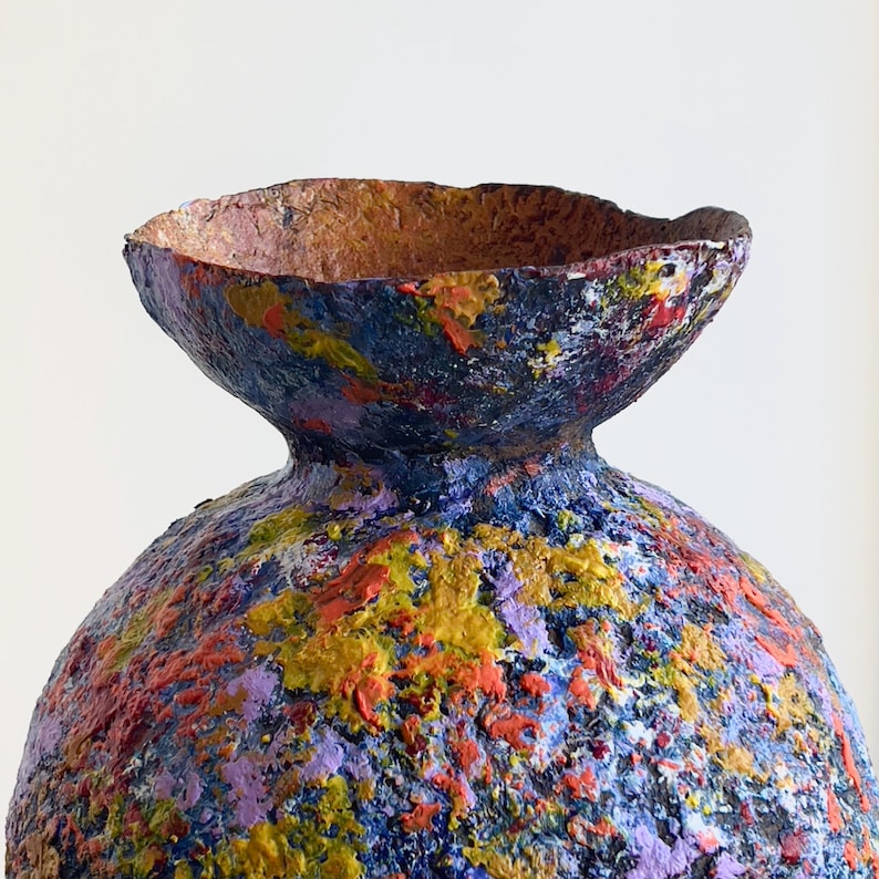 Sculptural paper clay vase with layered pigments and matte organic finish