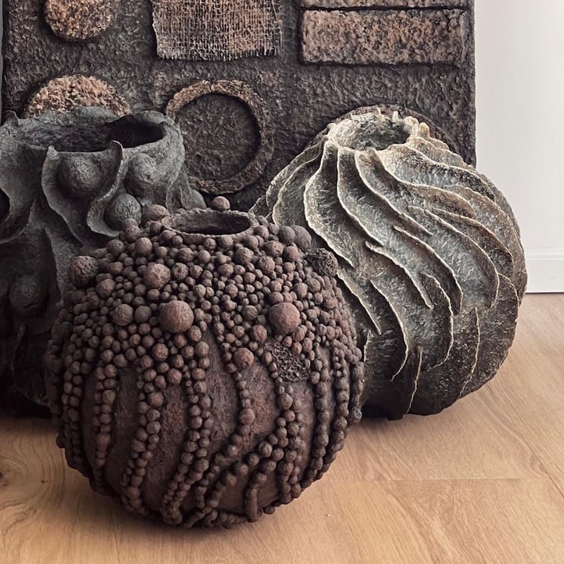 Biomorphic vase with dense spherical clusters in dark earthy paper-clay finish.