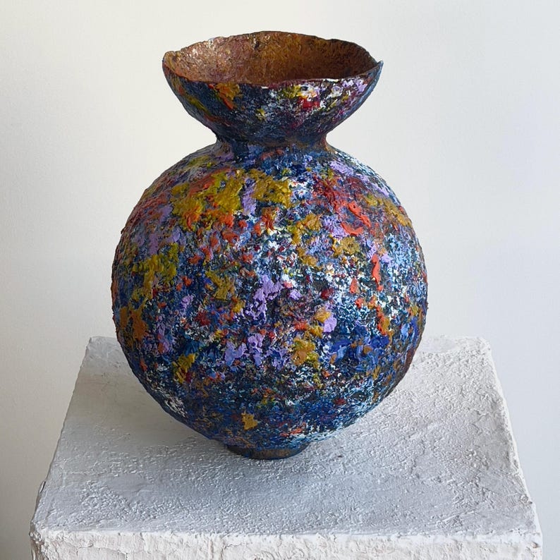 Close-up detail of layered paint texture on abstract sculptural vase