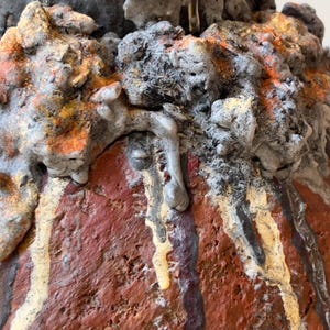 Textured ash and pigment sculpture