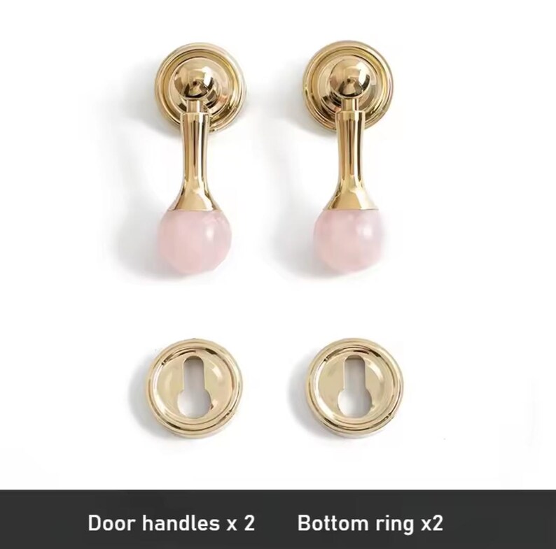 May include: Two gold door handles with pink crystal knobs and two matching gold bottom rings. Door handles x 2. Bottom ring x 2.