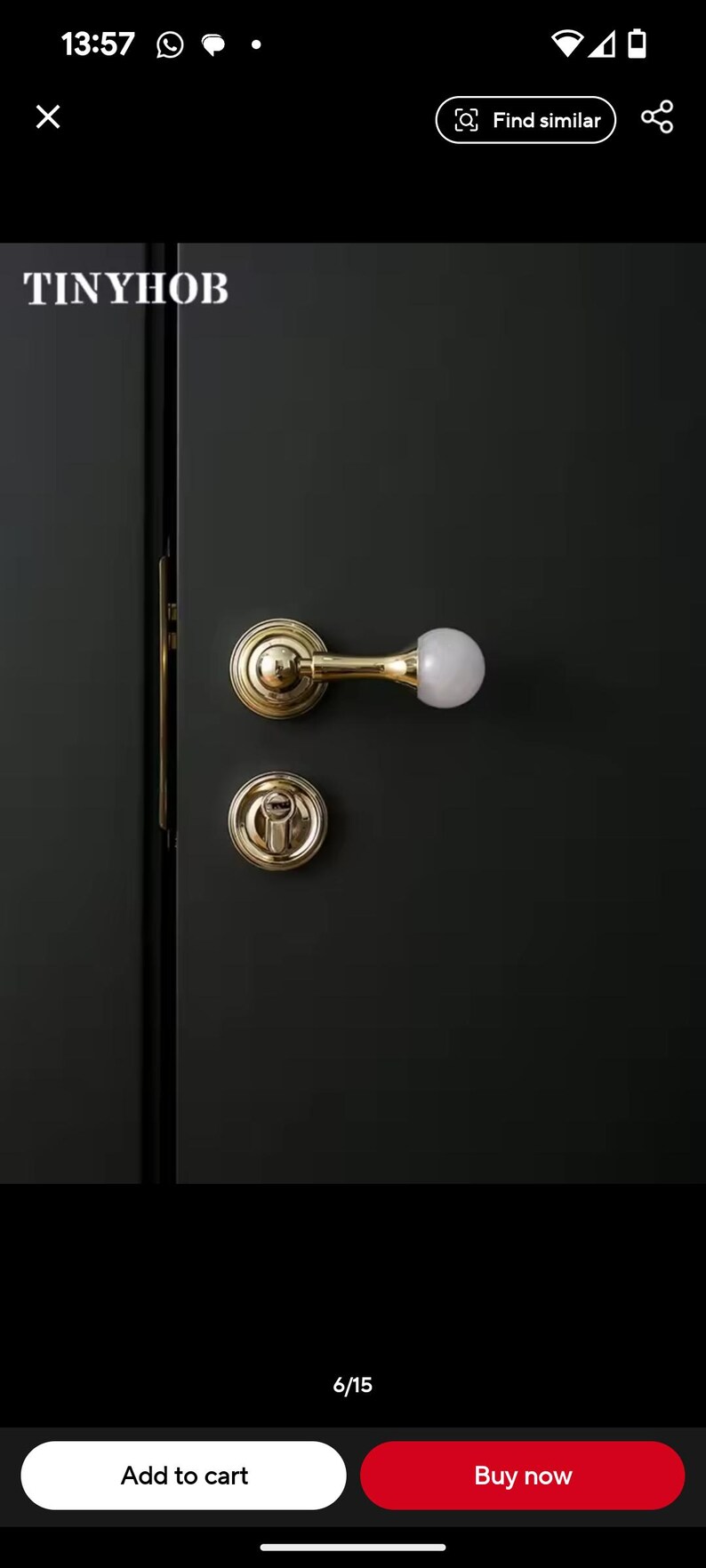 May include: A gold door handle with a white knob on a dark green door. The handle is a lever style with a round base. The door is closed.