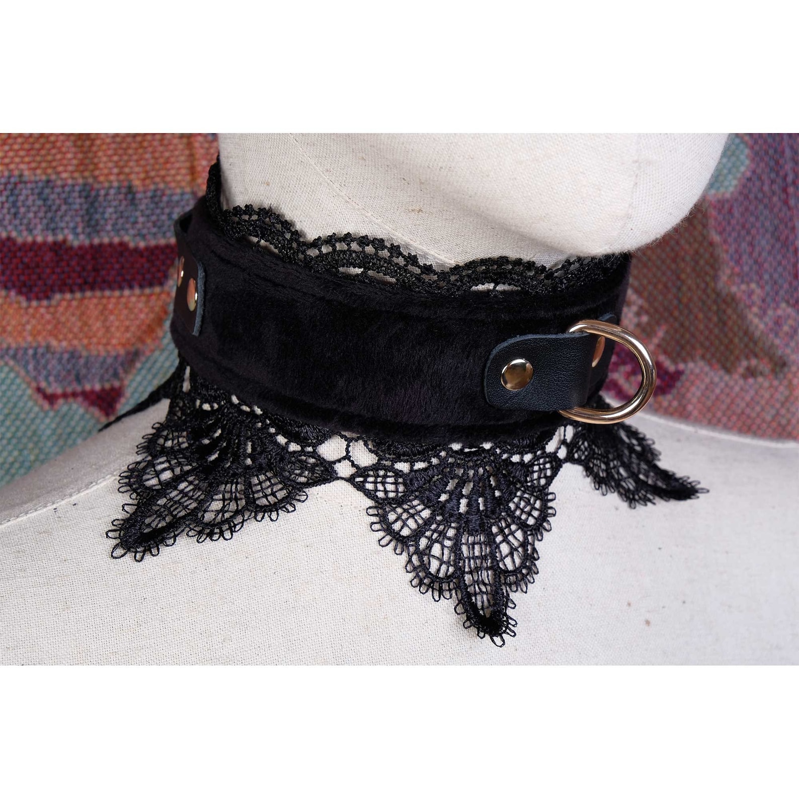 Side view of black lace bdsm collar with gold D-ring and plush faux fur texture, elegant and gothic restraint accessory.