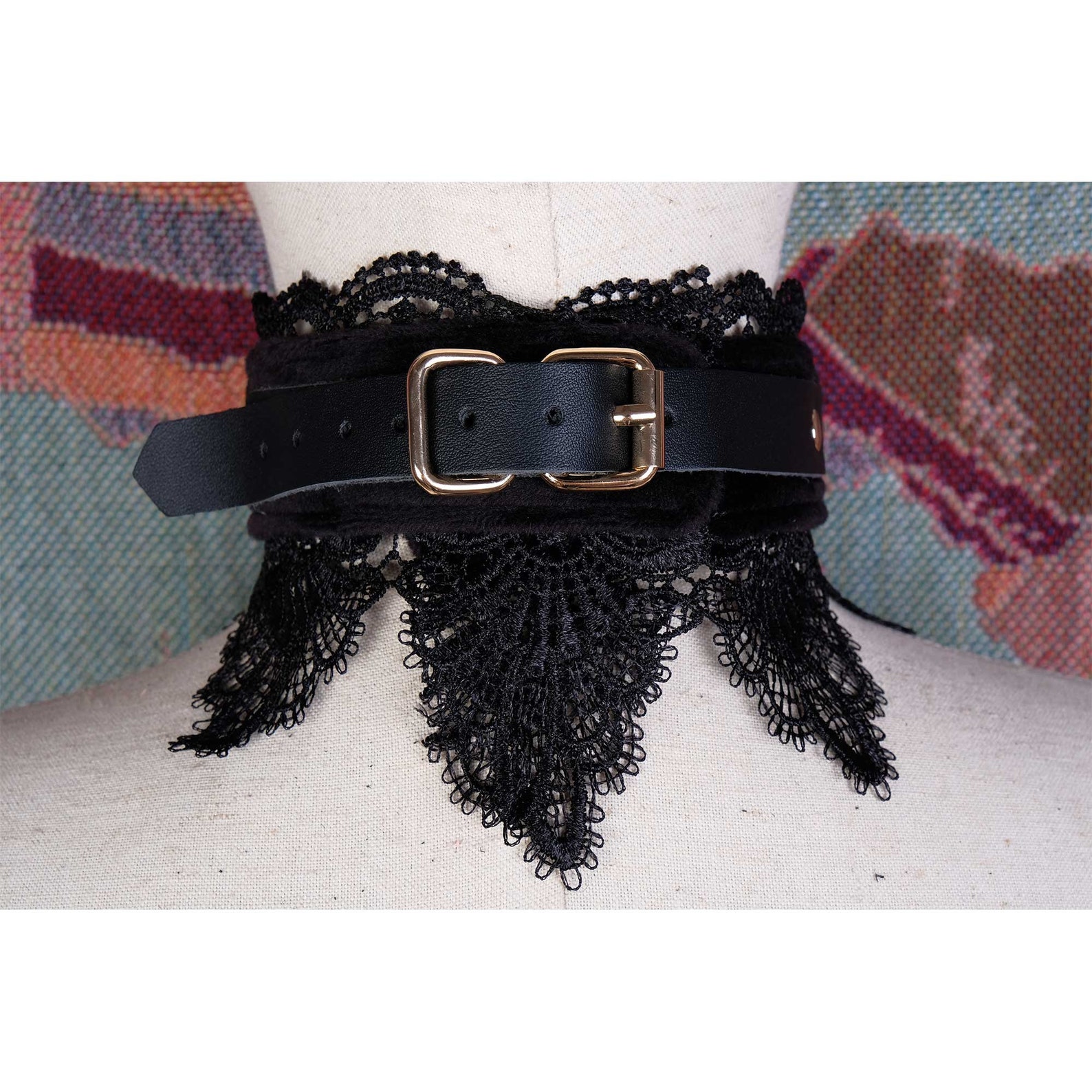 Back view of black leather bdsm collar with lace trim and gold buckle, detailed craftsmanship for bondage or fashion wear.