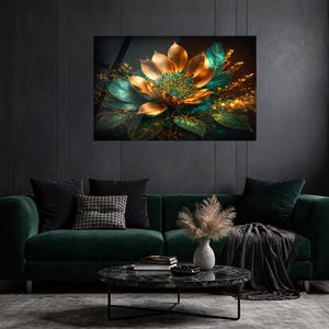 May include: A framed art print featuring a stylized golden flower with teal and green leaves. The artwork is displayed above a dark green velvet sofa with black pillows and a marble coffee table. The overall aesthetic is luxurious and modern.