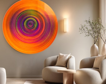 May include: A large, circular abstract art piece with a vibrant, concentric design. The artwork features a gradient of colors, including orange, pink, purple, and green, creating a dynamic visual effect. The piece is mounted on a neutral-toned wall, complementing the modern interior.