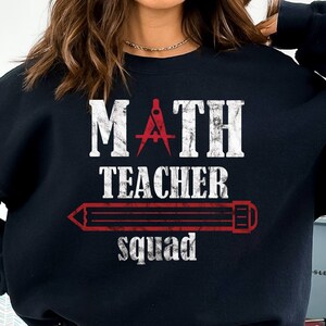May include: A black sweatshirt with the text "MATH TEACHER squad" in white with a red pencil and compass graphic.