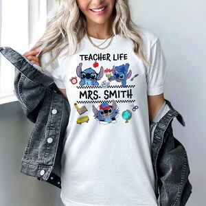 May include: White t-shirt with a blue Stitch character design. The shirt says "Teacher Life" and "Mrs. Smith".