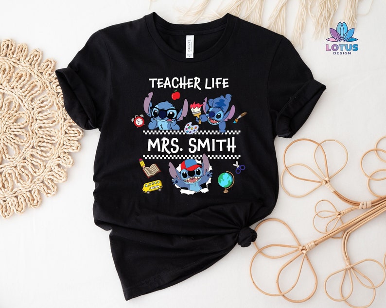 May include: Black t-shirt with a blue Stitch character design. The text "Teacher Life" and "Mrs. Smith" is printed on the shirt.