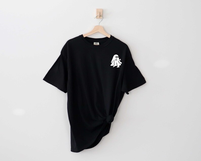 May include: Black t-shirt with a white ghost graphic on the front.