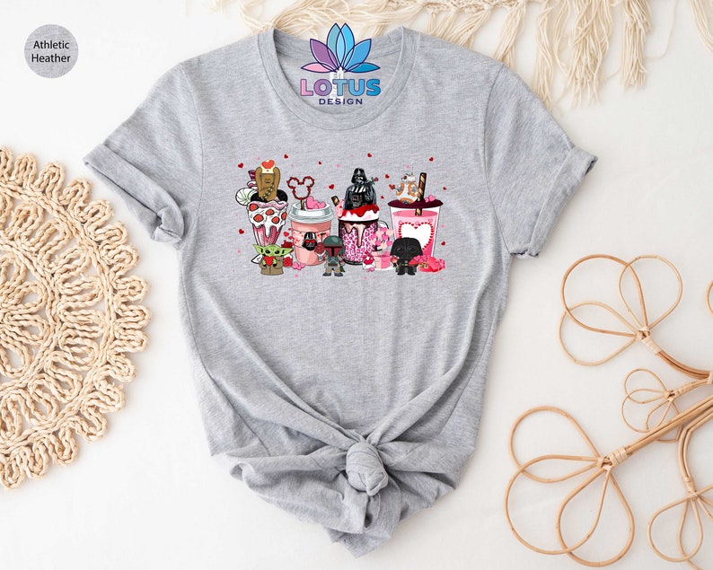 May include: Gray t-shirt with a graphic of Star Wars characters holding Valentine's Day themed drinks. The text "LOTUS DESIGN" is printed on the shirt.