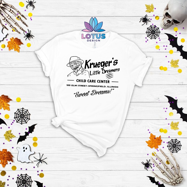 May include: White t-shirt with a black and white graphic of Freddy Krueger's Child Care Center. The text reads "Krueger's Little Dreamers Child Care Center 100 Elm Street-Springfield, Illinois "Sweet Dreams!"