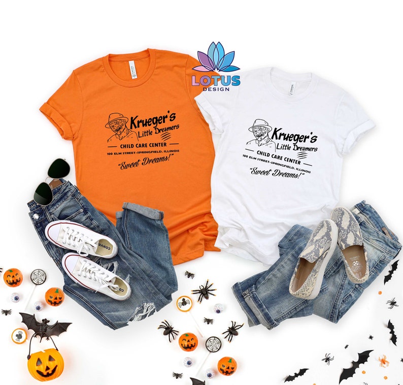 May include: Two white t-shirts with a vintage-style graphic design featuring a man in a hat and the text "Krueger's Little Dreamers Child Care Center 100 Elm Street Springfield, Illinois "Sweet Dreams!" "