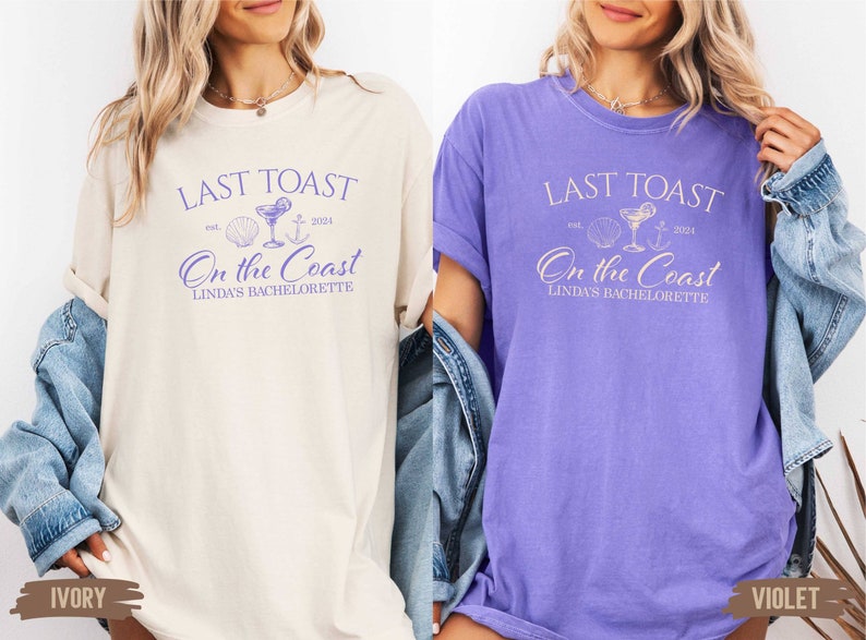 May include: Two t-shirts in ivory and violet with the text "Last Toast est. 2024 On the Coast Linda's Bachelorette" printed in purple. The design includes a seashell, a cocktail glass, and an anchor.